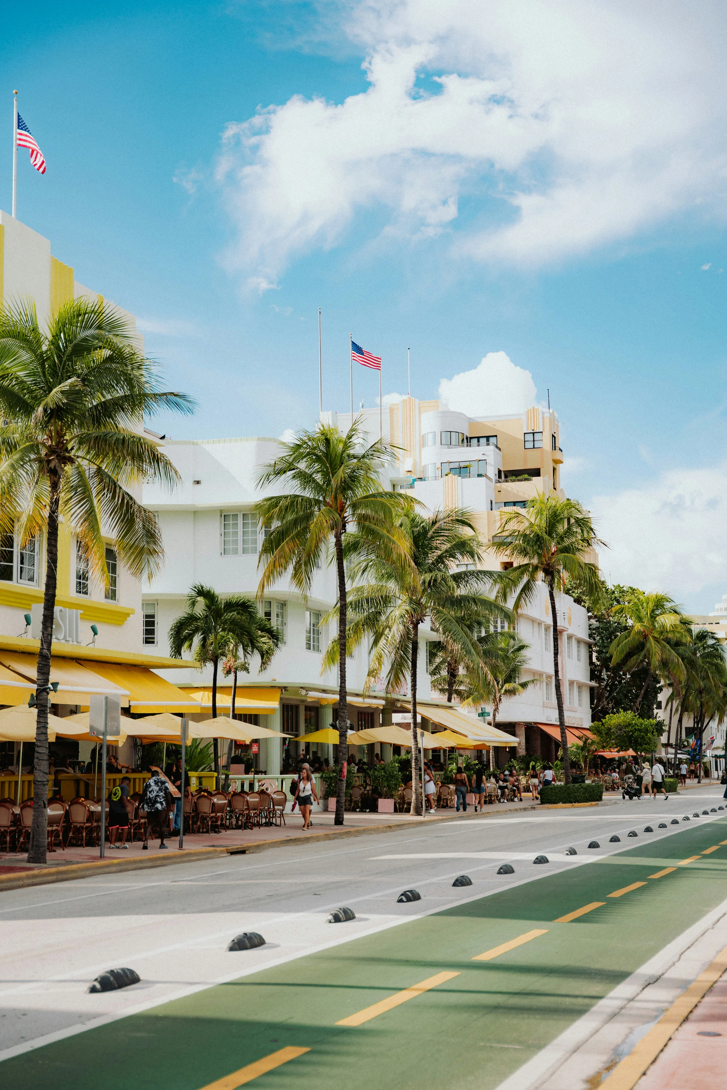 White Art Deco buildings with yellow awnings along Ocean Drive, South Beach